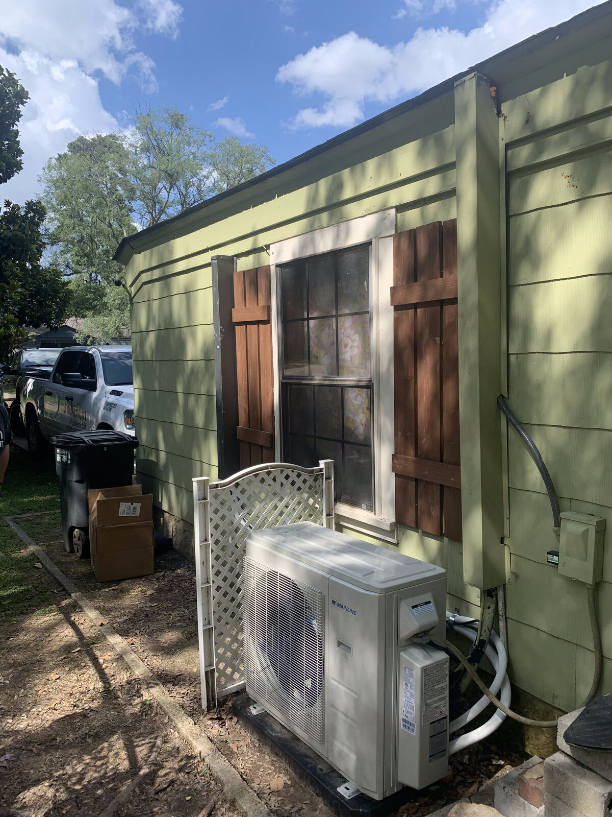 Mainline mini-split outdoor unit installed on a house