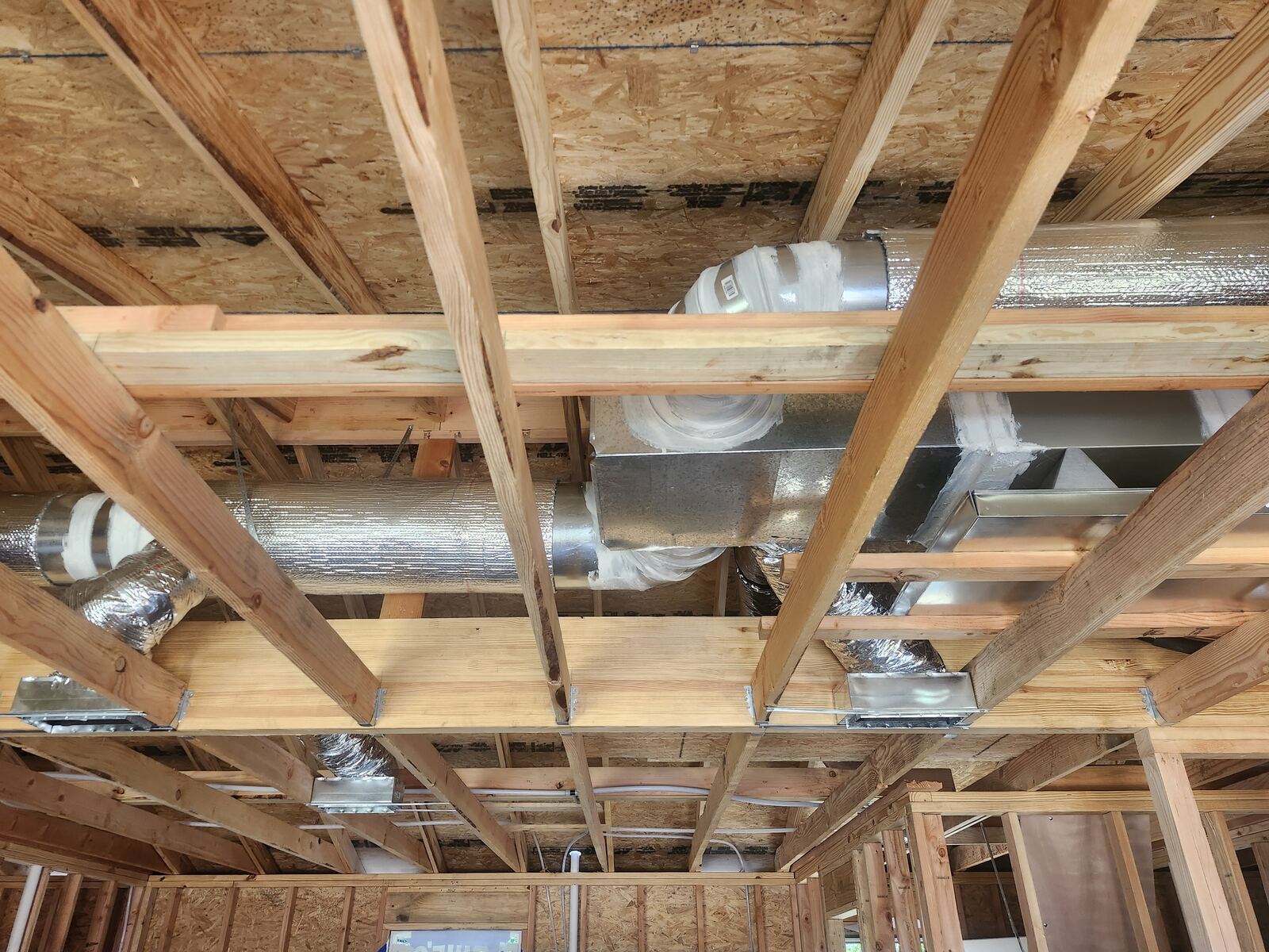 New construction trunk line and flex duct in open ceiling joists
