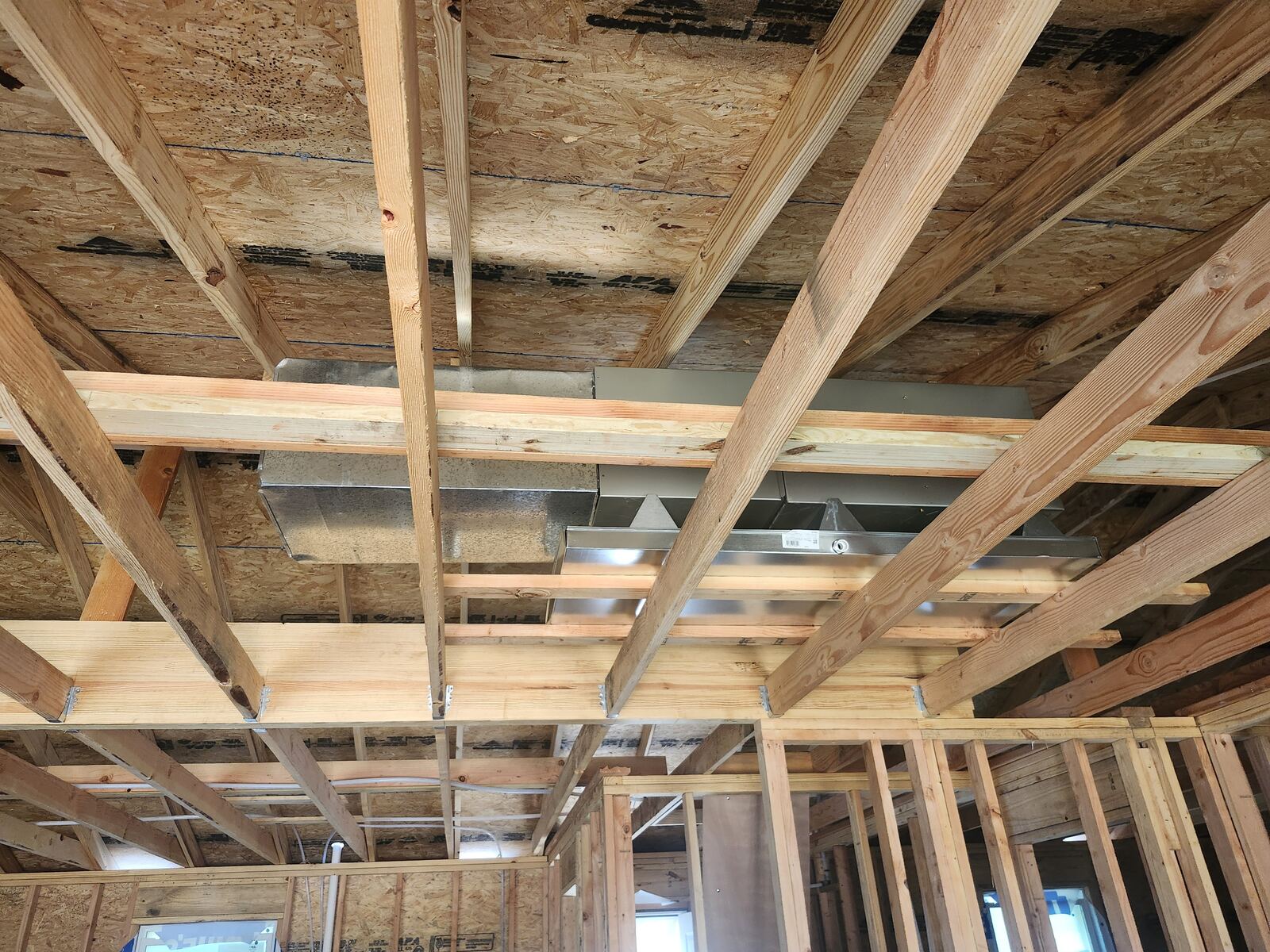 Air handler and supply plenum set in open ceiling framing