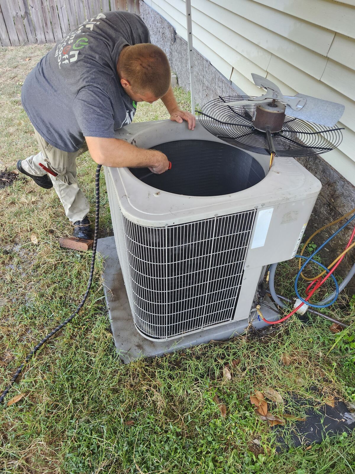 Air-On technician servicing a residential condenser in Texarkana