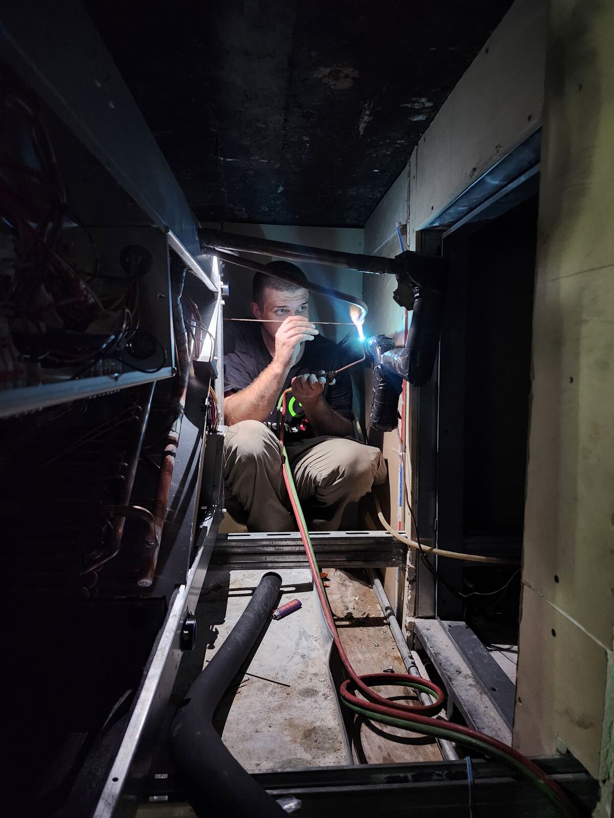 Air-On technician brazing a refrigerant line on a repair